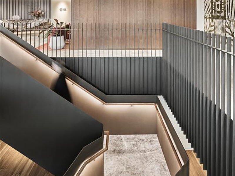 A stylish staircase constructed from wood and metal, highlighting a blend of natural and industrial elements.