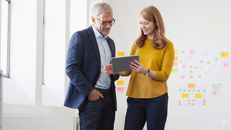 2 employees standing and discussing