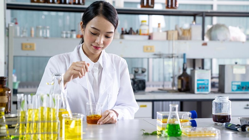 Female researcher conducting experiments in a life sciences laboratory