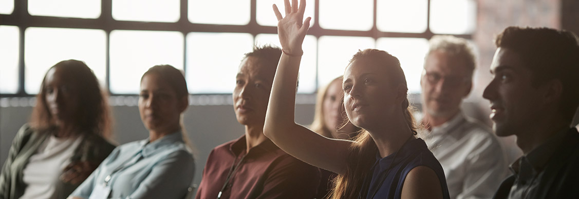 Girl raised her hand from the group of people