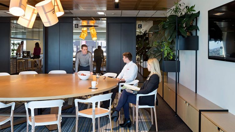 Three people discussing over table