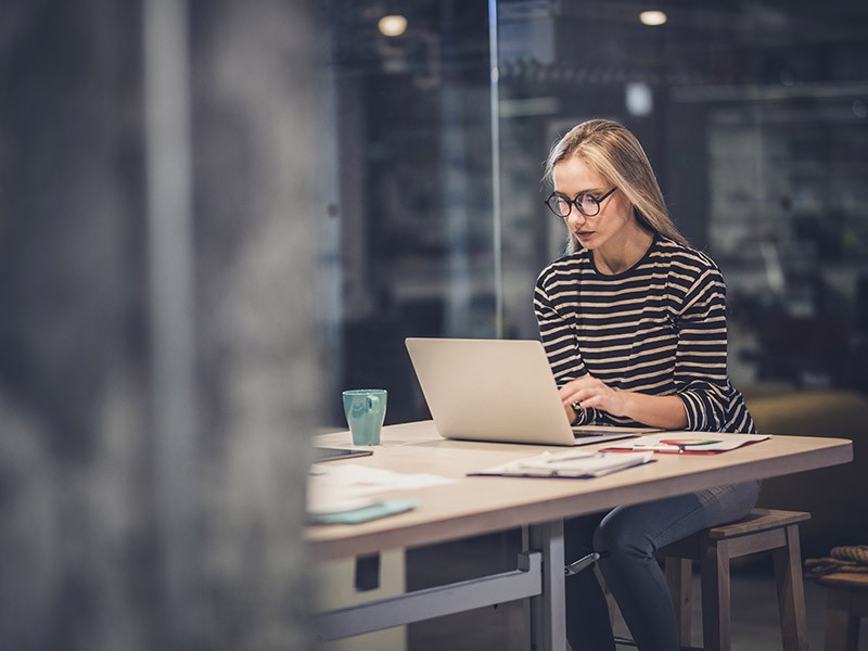 Young businesswoman typing on her computer in an office