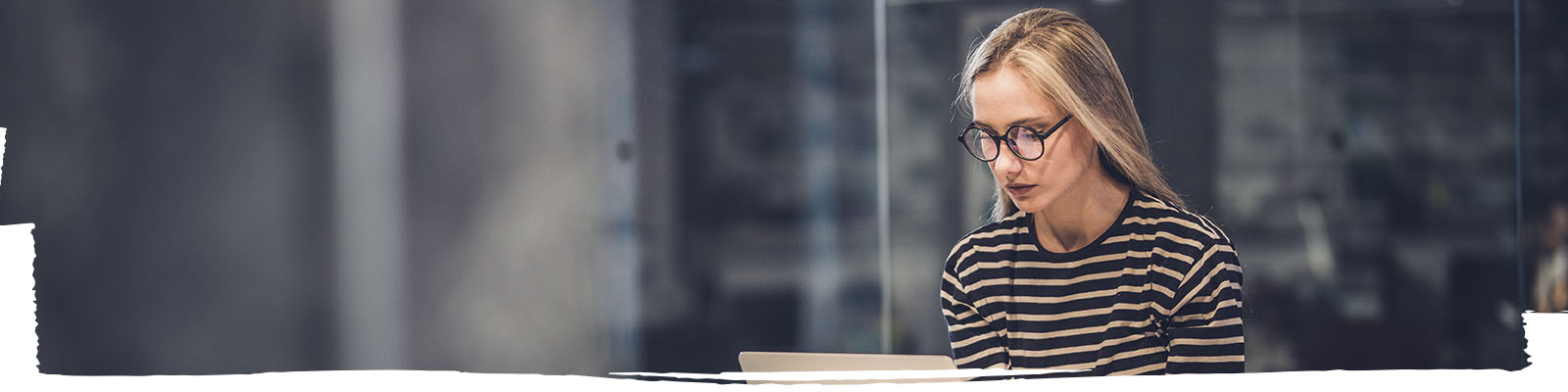 Young businesswoman typing on her computer in an office