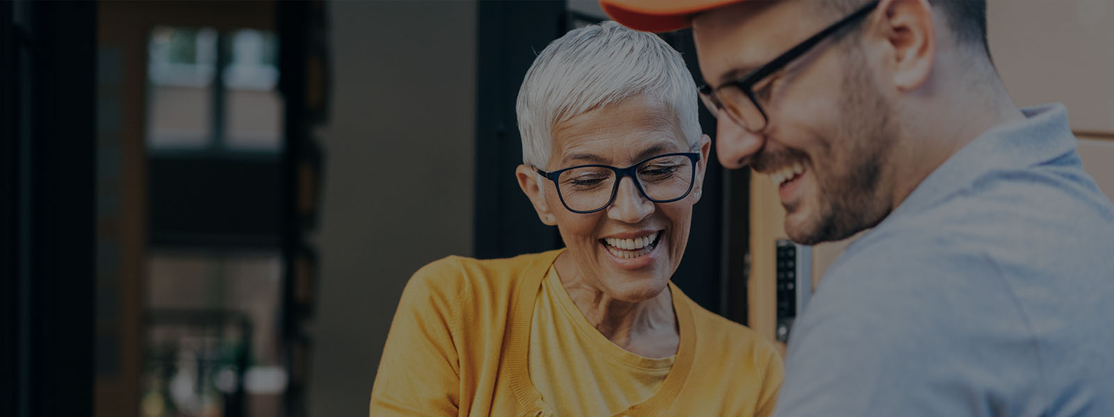 Smiling woman receiving delivery from delivery man 