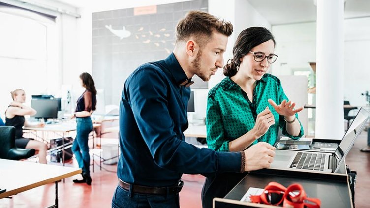 Two colleagues collaborating in their workplace.