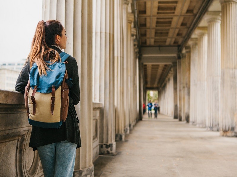 A young girl traveler or tourist or student with a backpack travels to Berlin in Germany; Shutterstock ID 1115041334