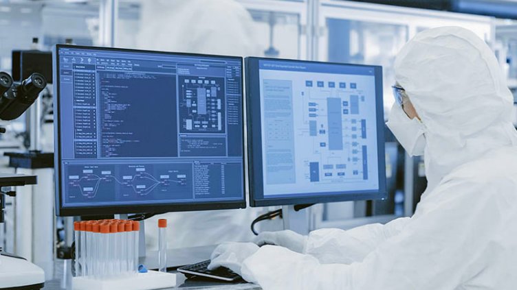 Life sciences researcher wearing mask and analyzing the research reports in the medical laboratory