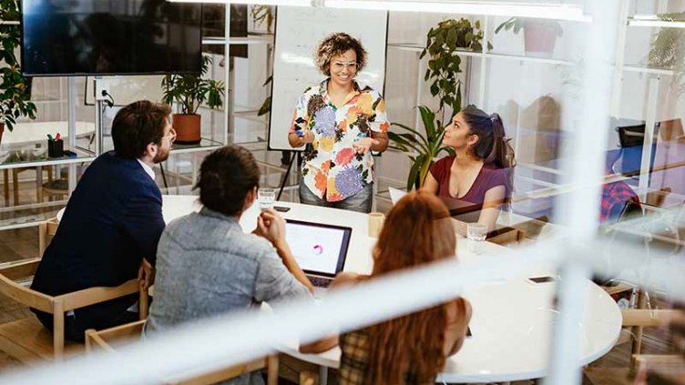 Office colleagues happily having a discussion in the conference room