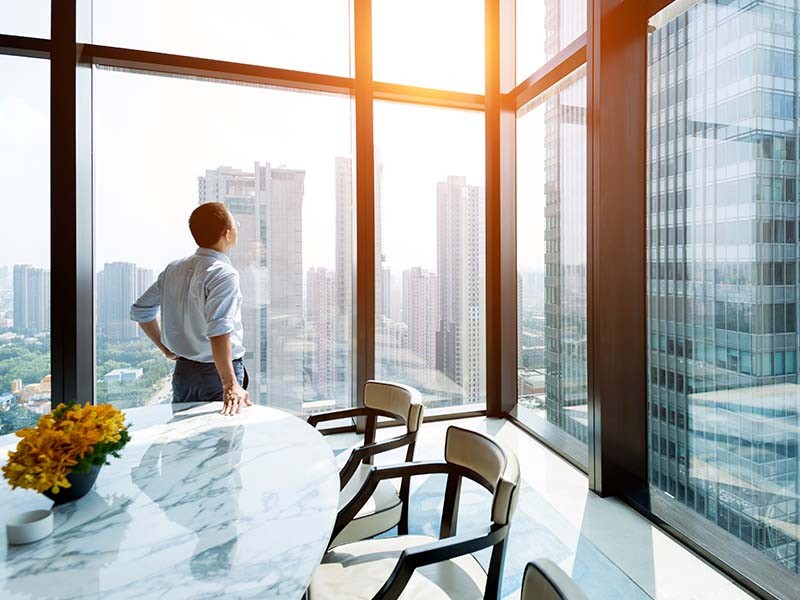 Man looking outside from office window 