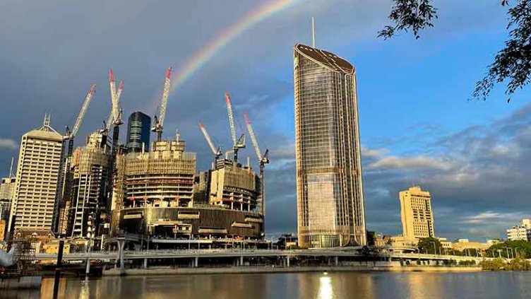 Building near to lake with rainbow behind