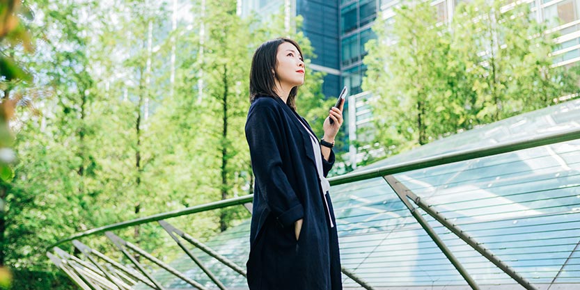 Women standing with a mobile