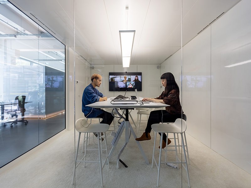 a man and a woman in a meeting room