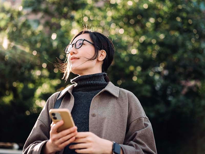 Women standing with a mobile