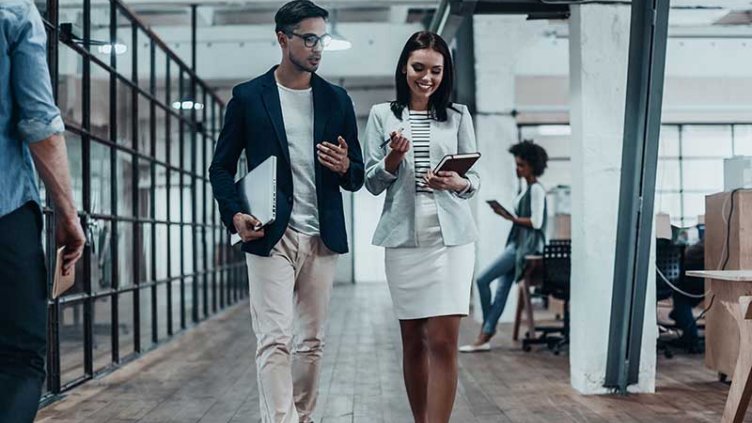 Employees talking while coming out from a meeting