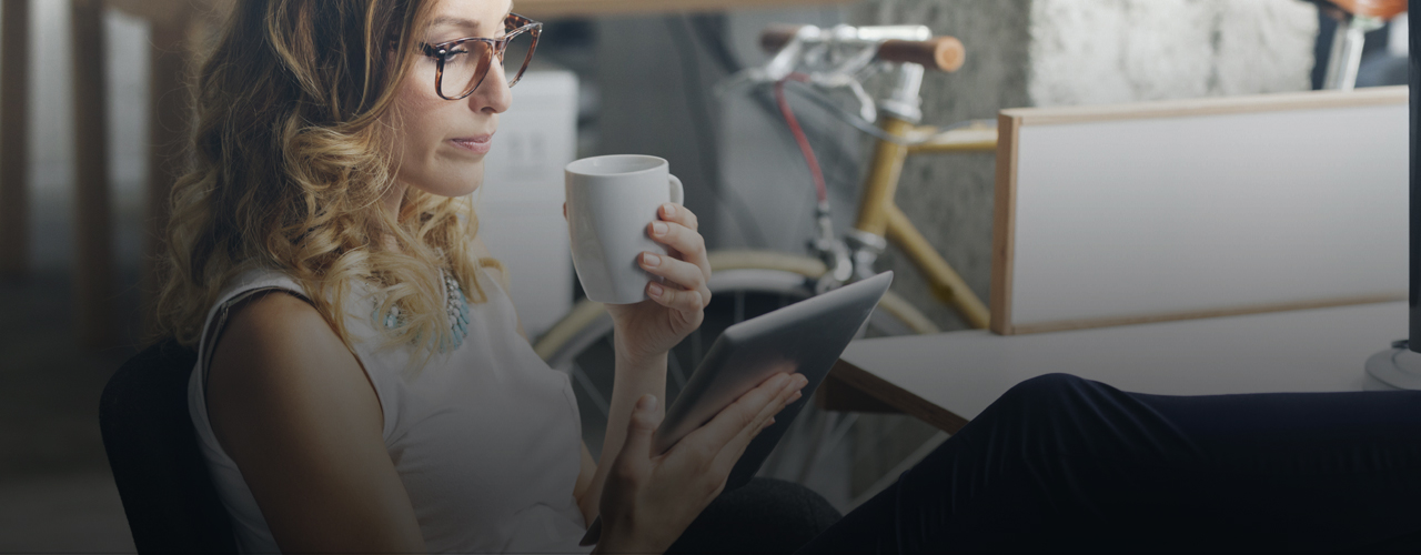 woman relaxing with a tablet and cup of tea