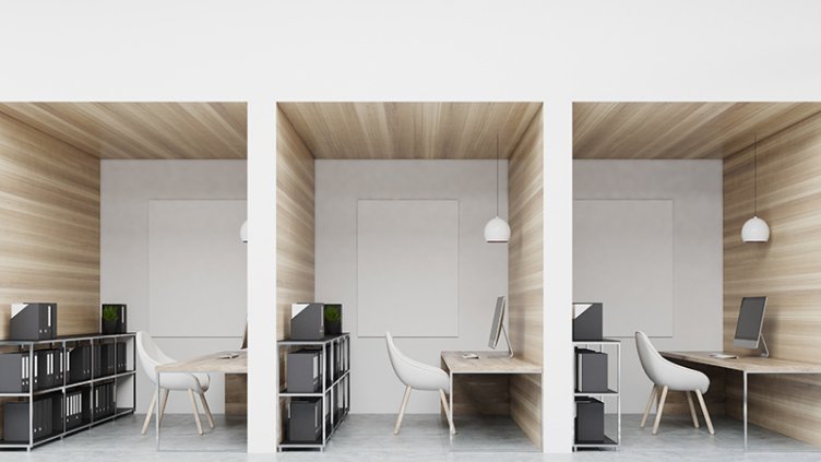 Office cubicles in an office with white and wooden walls. There are blank vertical pictures in each of them, a desk with a computer, a chair and shelves. 3d rendering mock up