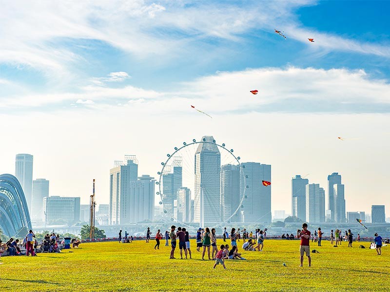 Group of people enjoying in the open area beside real estate office buildings