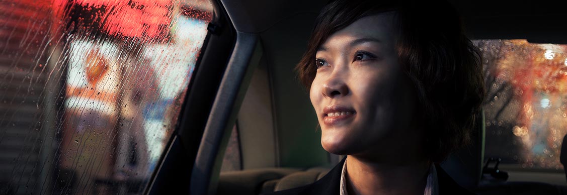 woman sitting in car looking outside