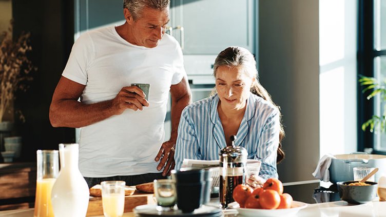Mature couple relaxing in their kitchen