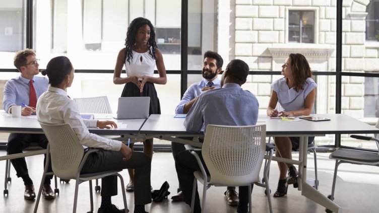 Female boss having informal meeting regarding workplace occupancy strategy