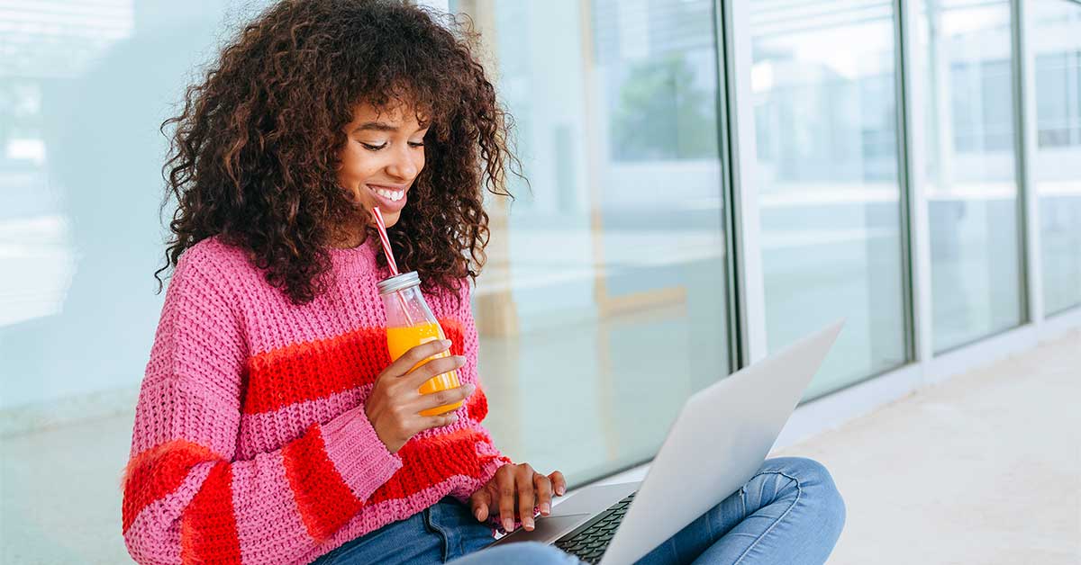 Woman working on laptop on balcony