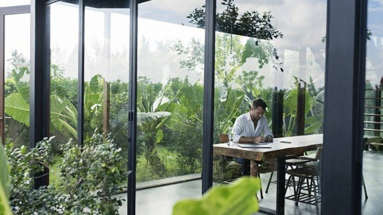 A man sitting and writing in an decarbonized room